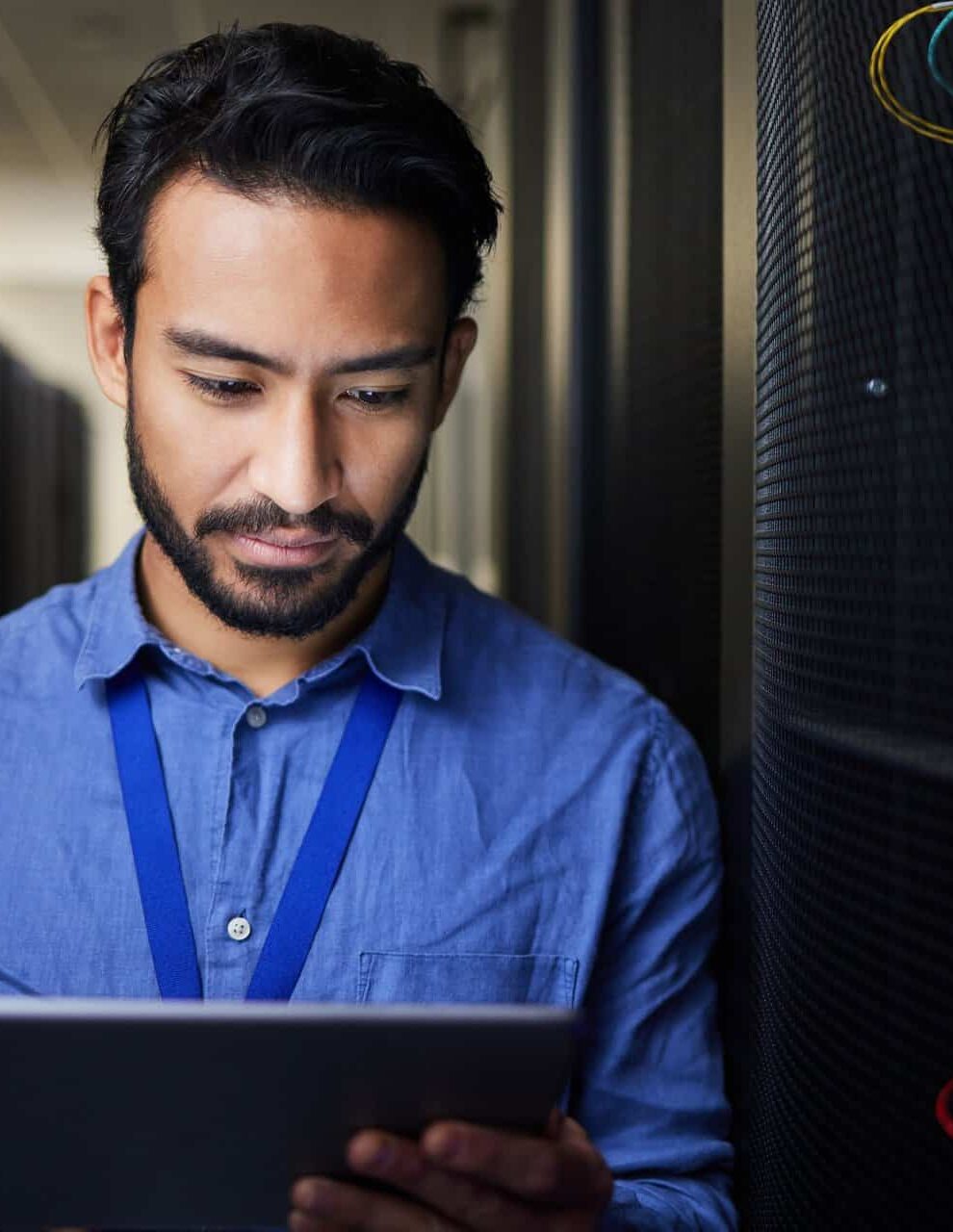 Tablet, man and engineer in server room on research for programming at night. Information technolog